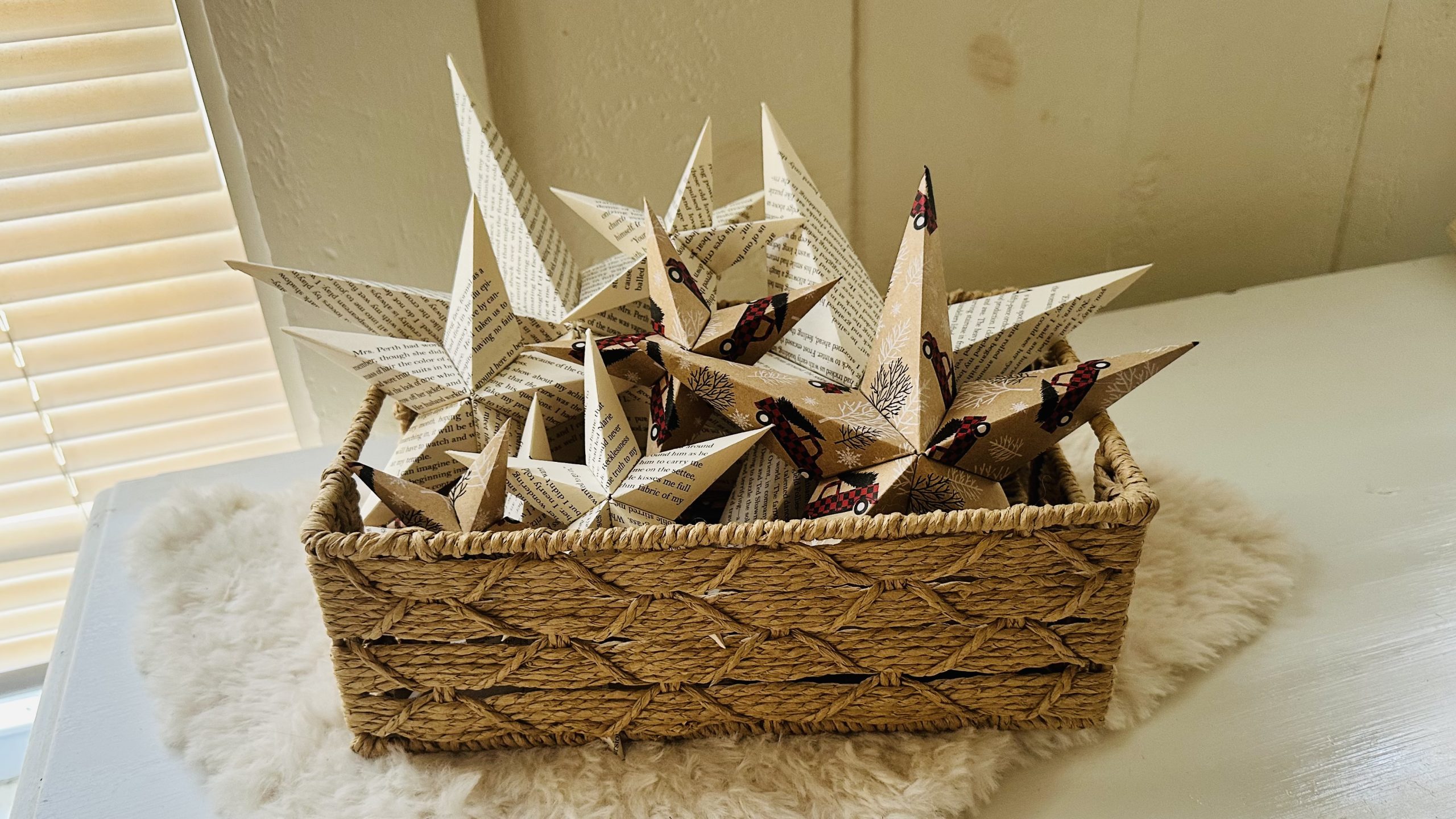 Upcycled paper star ornaments made from festive wrapping paper, created at Thrifty Bootique’s Starry Scraps Holiday Craft Class